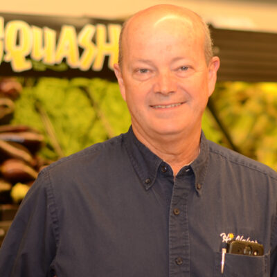 Smiling bald man in a grocery store