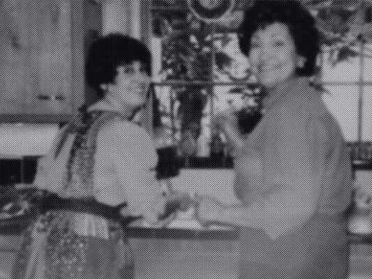 Black and white photo of two women in a kitchen